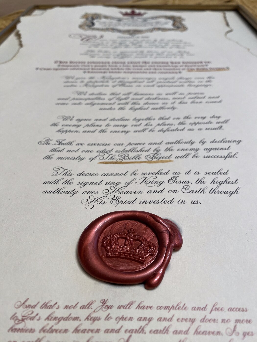 A framed, handwritten decree sealed with a crown wax seal